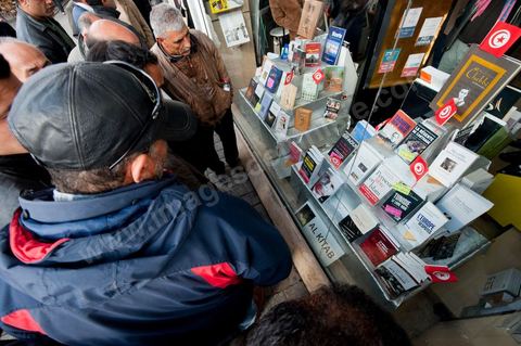 Attroupement devant la vitrine de la Librairie El Kitab sur l'avenue Habib Bourguiba, les tunisiens découvrent les ouvrages censurés par Ben Ali, encore en exemplaires uniques les ouvrages sur la dictature de Ben Ali de Taoufik Ben Brij ou "La régente de Carthage" s'affichent aujourd'hui en vitrine.