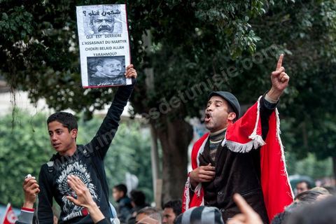 23 février 2013 : la foule brandit le portrait de Chokri Bealid. près de 3000 partisans et citoyens sont venus protester devant le Ministère de l'Intérieur pour la lenteur de l'enquête sur l'assassinat du militant politique Chokri Belaid le 6 février dernier. Les slogans ont aussi accusé le parti au pouvoir Ennahdha et son dirigeant Rached Ghannouchi.