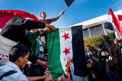 29 mars 2013 : les militants tunisiens du parti Bass pro Bachar El Assad sur la place centrale du FSM brule le drapeau des rebelles syriens au dernier jour des rencontres du Forum Social Mondial sur le campus universitaire de Tunis. Ce premier forum en Terre arabe a été fortement marqué par les revendicatiosn et constatestations nationaliste arabes, et dominé par un hommage et soutien constant au peuple palestinien.