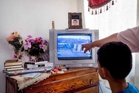 A Kabaria, quartier populaire de la banlieue sud de Tunis, Chez Nourredine MBAREK, père de Karim disparu le 29 mars 2011. Nourredine et un de ses jeunes fils nous montrent sur le reportage de Canale5 tourné à Lampedusa son fils Karim.