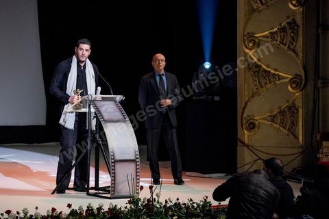 28 novembre 2015 : Prix du Jury à Nabil AYouch, réalisateur marocain du film "Much Loved". Cérémonie de cloture des JCC au théâtre municipal de Tunis au coeur de la capitale meutrie il y a quelques jours à peine par une attaque suicide terroriste qui a fait 12 morts parmis les policiers de la garde présidentielle. La cérémonie avancée pour cause de couvre feu a été un moment d'hommage à la culture qui a su faire face à la terreur durant cette semaine et l'occasion de primée les artistes et réalisateur du monde arabo-africain. 