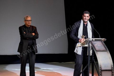 28 novembre 2015 : Prix du Jury à Nabil AYouch, réalisateur marocain du film "Much Loved". Cérémonie de cloture des JCC au théâtre municipal de Tunis au coeur de la capitale meutrie il y a quelques jours à peine par une attaque suicide terroriste qui a fait 12 morts parmis les policiers de la garde présidentielle. La cérémonie avancée pour cause de couvre feu a été un moment d'hommage à la culture qui a su faire face à la terreur durant cette semaine et l'occasion de primée les artistes et réalisateur du monde arabo-africain. 