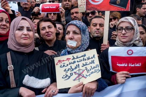 6 décémbre 2016 : Plus de 2.000 avocats ont manifesté mardi à Tunis contre les nouvelles dispositions fiscales qui leur ont été imposées dans le projet de budget 2017, actuellement examiné par le Parlement."Avec notre âme, avec notre sang nous défendrons le métier d'avocat", ont crié les manifestants en robe noire devant le siège du gouvernement à la Kasbah, dans le centre de Tunis, après une marche de quelques centaines de mètres."Les avocats sont en colère!", "Nous n'allons pas financer votre corruption", pouvait-on lire sur des pancartes brandies par les protestataires, dont beaucoup jugent les nouvelles mesures "injustes" et "inapplicables".En cause, des taxes imposées pour chaque dossier traité, pouvant être déduites de l'impôt sur le revenu et prévues dans le projet de loi de finances 2017.Ce mouvement ne fait toutefois pas l'unanimité, et sur les réseaux sociaux comme dans certains médias, les protestations des avocats ont été considérées comme une volonté de bénéficier d'un traitement spécial. Selon le webzine Inkyfada, qui a analysé des données officielles, 60% des avocats enregistrés n'ont pas déclaré d'impôts en 2015, et "les avocats en règle paient en moyenne 228 dinars (92 euros) d'impôt sur le revenu par mois".