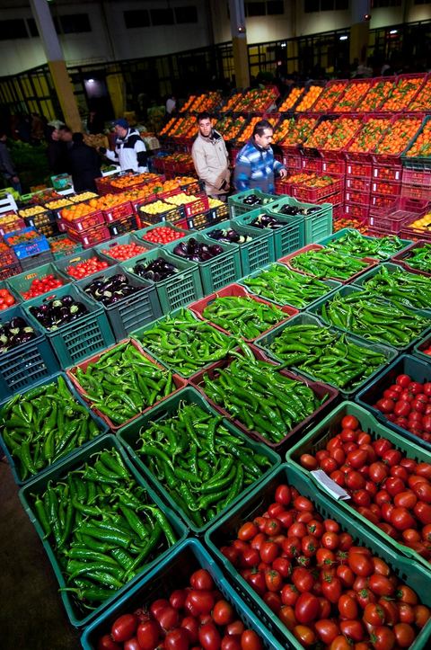 Etale et vendeurs de tomates, poivrons et oranges à la Halle aux fruits et légumes du marché de gros de Tunis à El MouroujHalle aux fruits et légumes du marché de gros de Tunis à El Mourouj