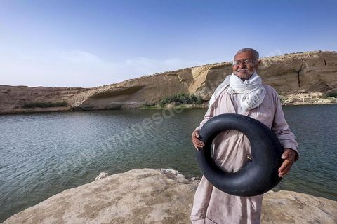 Belgacem came with some friends to go swimming in the lake at "Gafsa Beach." Since he didn't know how to swim, he made a float out of an inner tube.