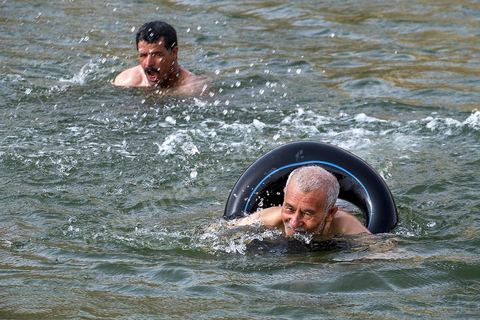 Belgacem came with some friends to go swimming in the lake at "Gafsa Beach." Since he didn't know how to swim, he made a float out of an inner tube.