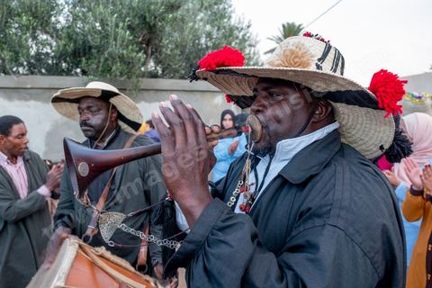 Avant le mariage, un cortège traverse les villages et la campagne de Djerba pour transporter le trousseau et les cadeaux offerts à la mariée, portés dans des couffins décorés. La marche est ouverte par des musiciens traditionnels, tambour et zokra en tête, qui annoncent le passage du cortège de maison en maison. Femmes et enfants du voisinage se joignent au passage, dans une ambiance de fête qui marque l'un des temps forts des préparatifs du mariage djerbien.