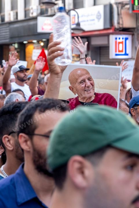 Tunis, Tunisia – August 20, 2026. Protesters march through downtown Tunis against President Kaïs Saïed, calling for his resignation and demanding greater political freedoms and the release of detainees and opposition figures. Portraits of the president crossed out with the slogan “GET OUT,” Tunisian flags, and signs accompany the protest. The protest comes amid growing social discontent following several weeks of extreme heat, water and power outages, and difficulties in accessing certain medications and essential goods.
